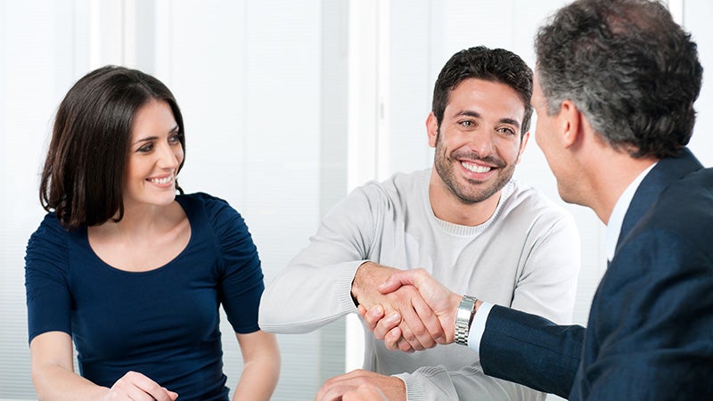 couple shaking hands with salesman Stevens Point Auto Center in Stevens Point WI